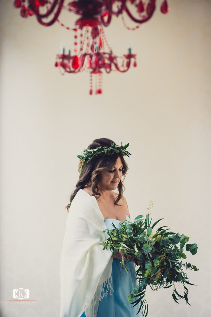 Elope to Ireland elopement in dublin ireland on a cliff bride with flowers before the ceremony