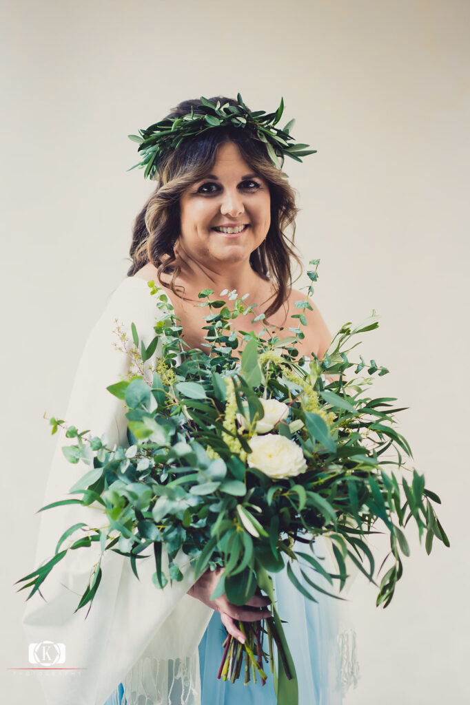 Elope to Ireland elopement in dublin ireland on a cliff bride with flowers before the ceremony